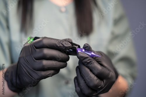 Professional apparatus for working with eyebrows in master hands  close up. Microblading tools used for applying permanent eyebrow makeup and tattoo