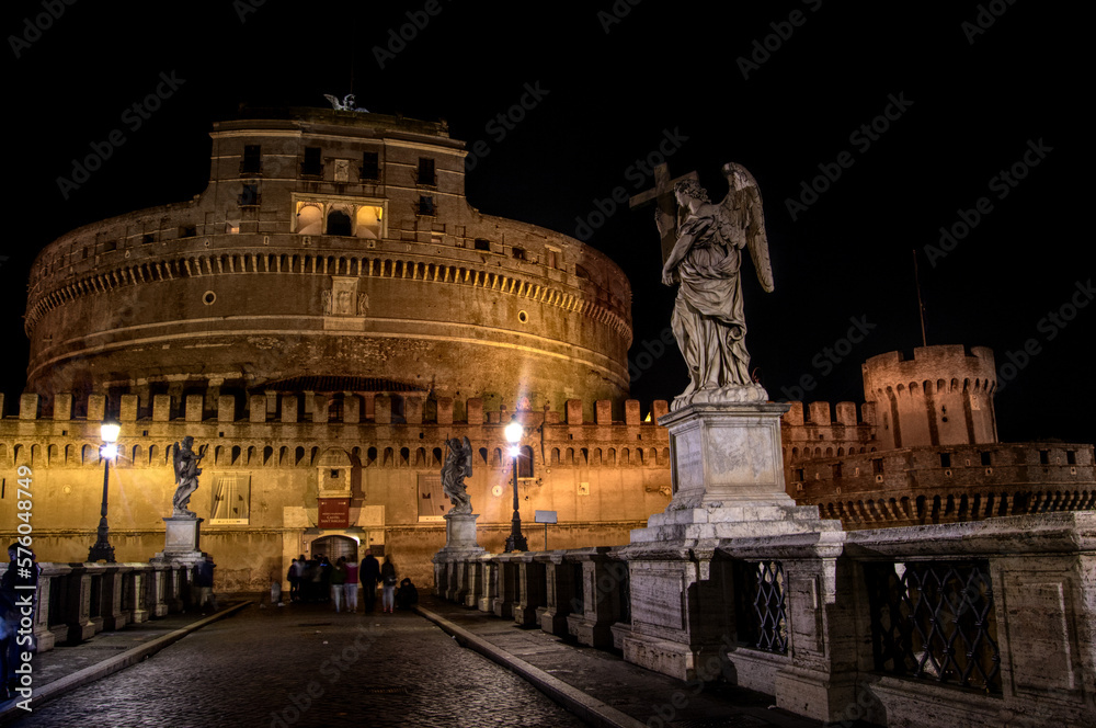 Castel Sant Angelo and angel statue on Saint Angelo bridge in Rome Italy at night
