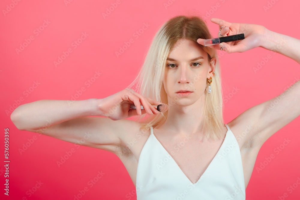 Handsome man wearing make up and woman clothes looking at the camera. positive person. Handsome man wearing make up and woman clothes looking at the camera. positive person.