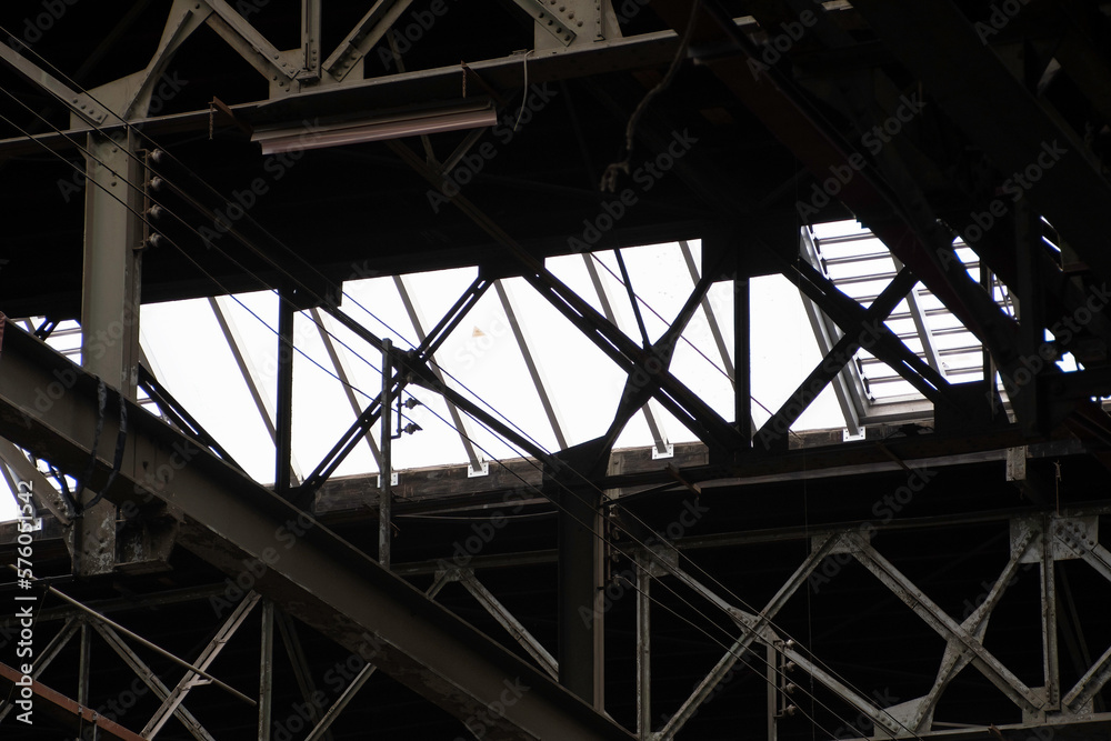 Large interior industrial metal beam roof construction in old factory shipyard at amsterdam, the netherlands. Dark urban scene architecture structure background Large interior industrial metal beam roof construction in old factory shipyard at amsterdam, the netherlands. Dark urban scene architecture structure background
