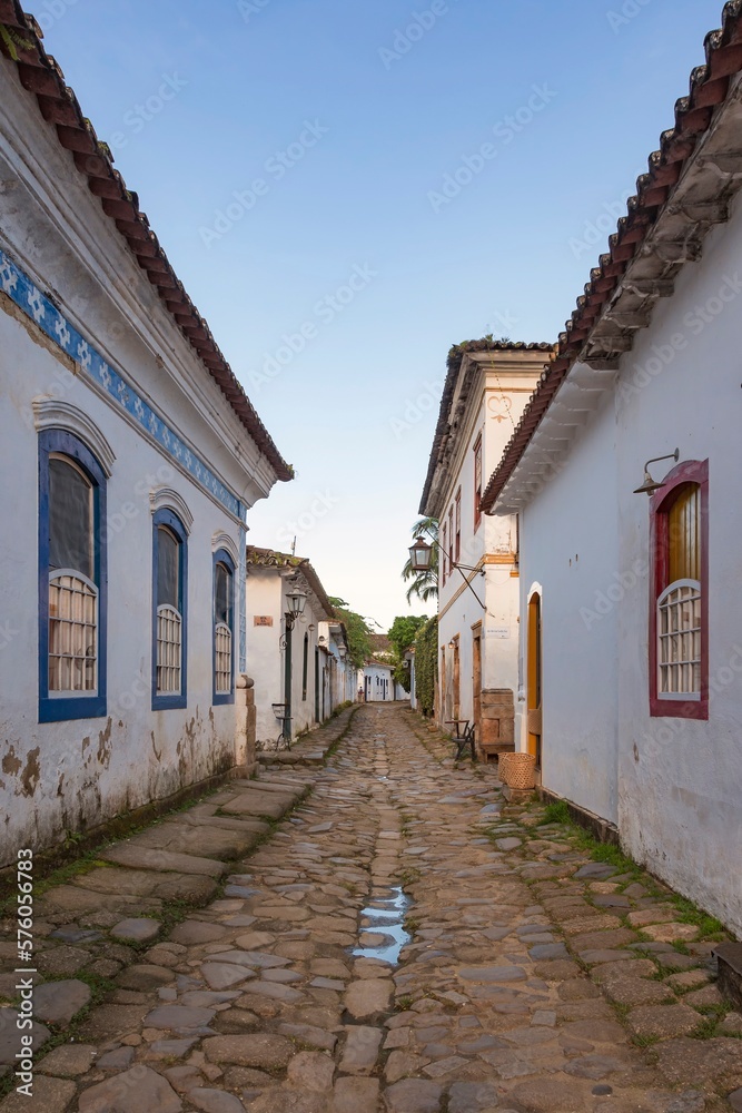 Paraty, Rio de janeiro, Brazil. Old street and houses from the colonial period. Stone street floor. Background blue sky.