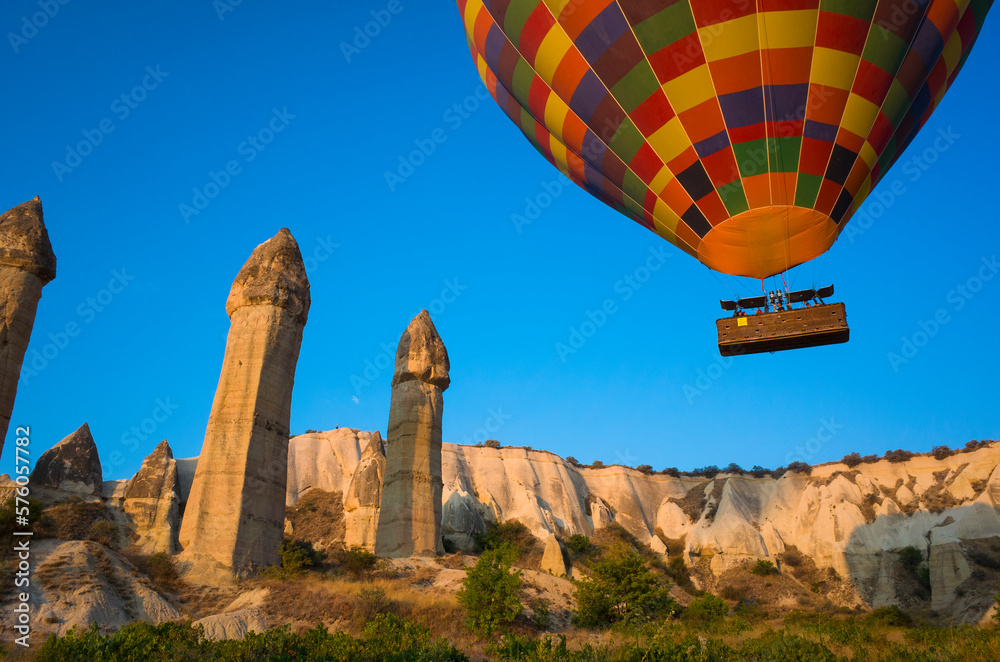 Cappadocia Love Valley, Hot air balloon flying over unique geological formations Fairy Chimneys in Goreme National Park, Popular tourist destination in Turkey