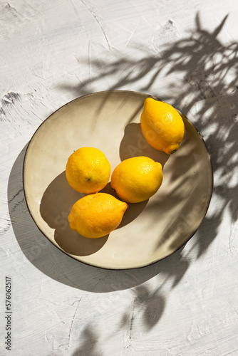 Fresh yellow lemons in the garden under the summer sun