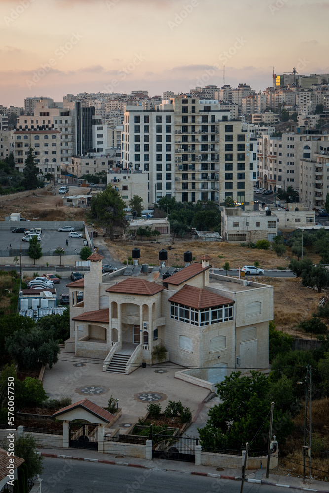 Ramallah Cityscape at Dawn with Sunset, High Buildings and Trees Facing the Sun