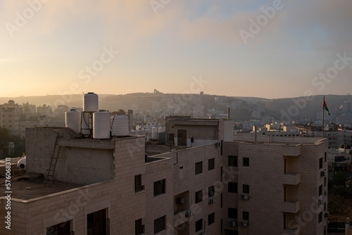 Ramallah Cityscape at Dawn with High Buildings and Mountains Facing the Sun
