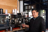 Coffee Master: Portrait of the Barista preparing the perfect espresso