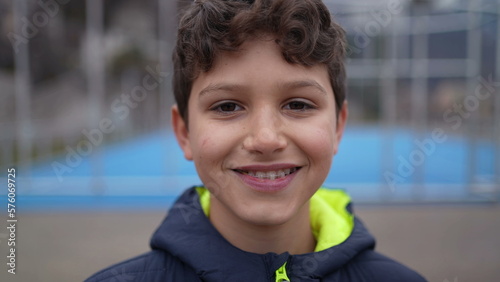 Fotografi Portrait of a happy handsome young boy standing outside