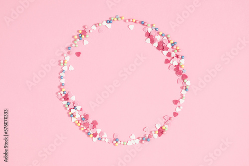 Easter holiday composition. Easter decorations, colorful sugar candy sprinkles isolated on pastel pink background. Easter concept. Flat lay, top view, copy space 