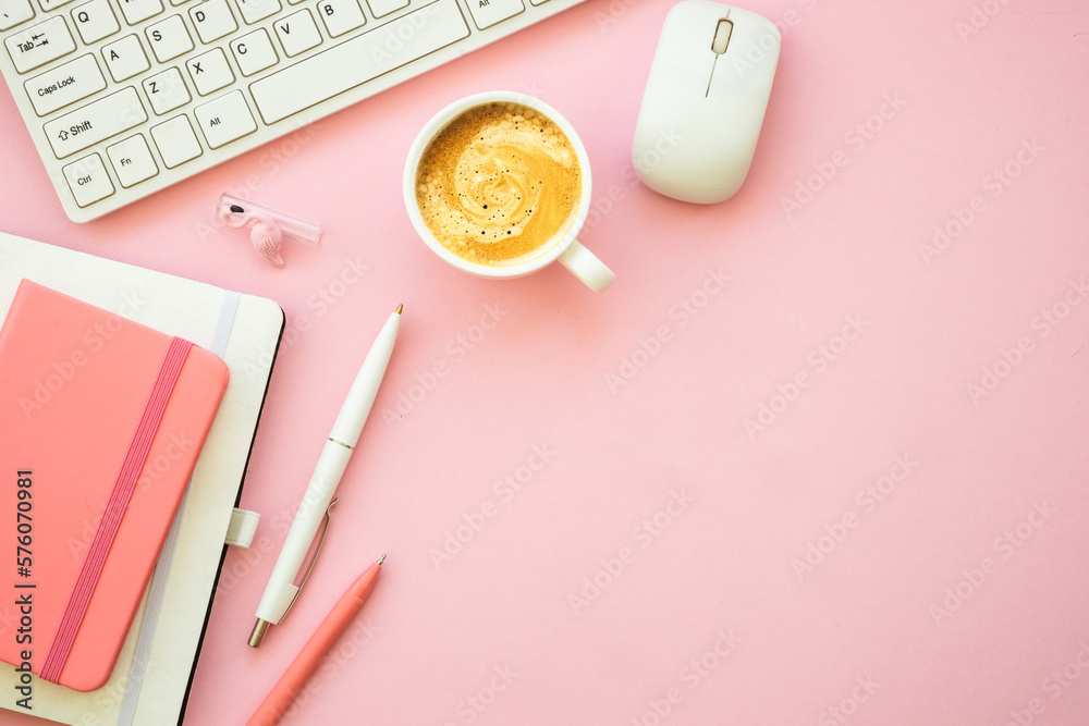 Home office workspace. Pink flat lay office desk with keyboard, notebook and coffee cup.. Home office workspace. Pink flat lay office desk with keyboard, notebook and coffee cup..
