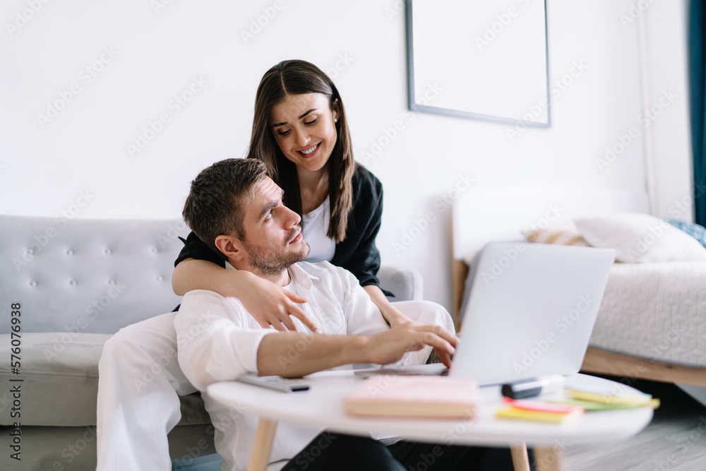 Happy couple using laptop at home Happy couple using laptop at home