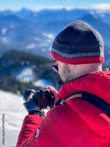 Bavarian Hiker life with camera photo shooting at snow landscape