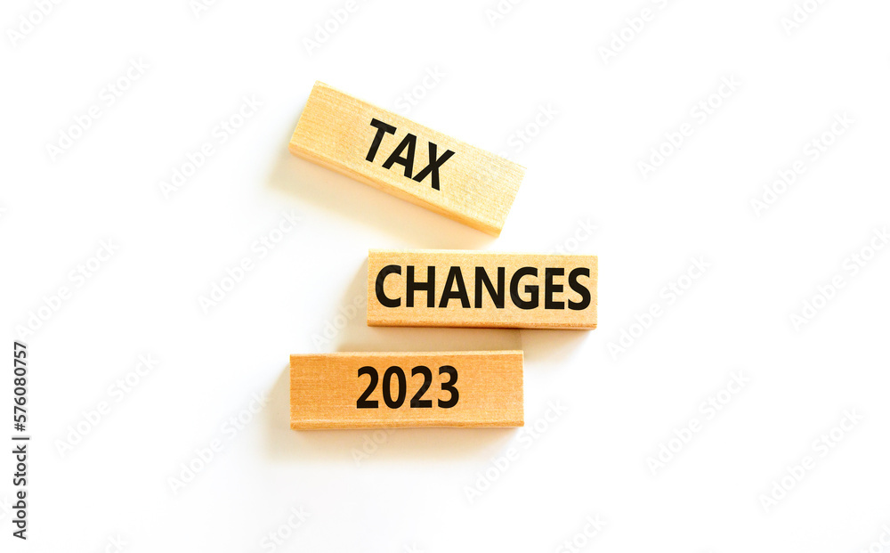 Tax changes 2023 symbol. Concept words Tax changes 2023 on wooden blocks on a beautiful white table white background. Business Tax changes 2023 concept. Copy space.