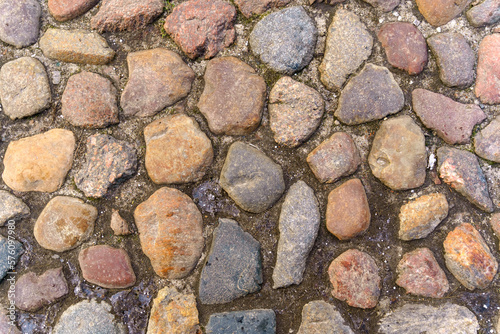 Abstract background of old cobblestone close up.