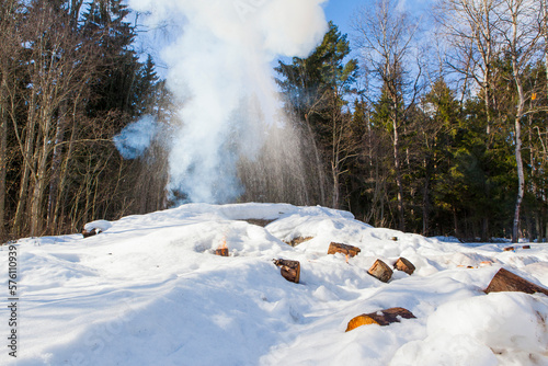 russian military tank with soldiers in ukraine in winter goes on the attack under fire