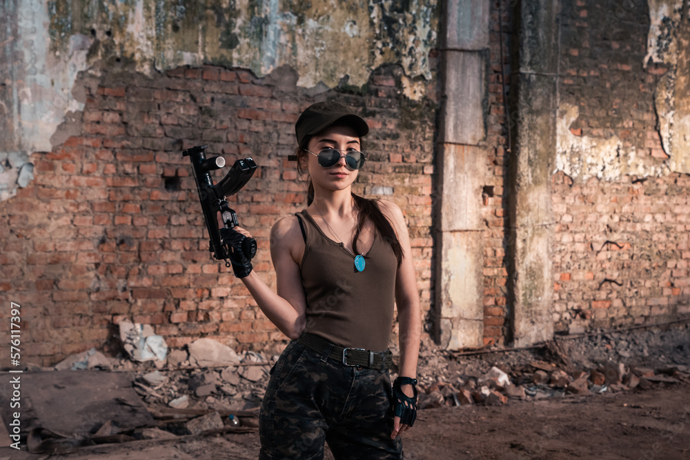 Fototapeta premium Female soldier with weapons. Character from the comic book The Punisher. Armed with a pistol and machine gun. A dangerous person who solves problems with force.