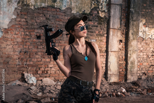 Female soldier with weapons. Character from the comic book The Punisher. Armed with a pistol and machine gun. A dangerous person who solves problems with force. © algrigo