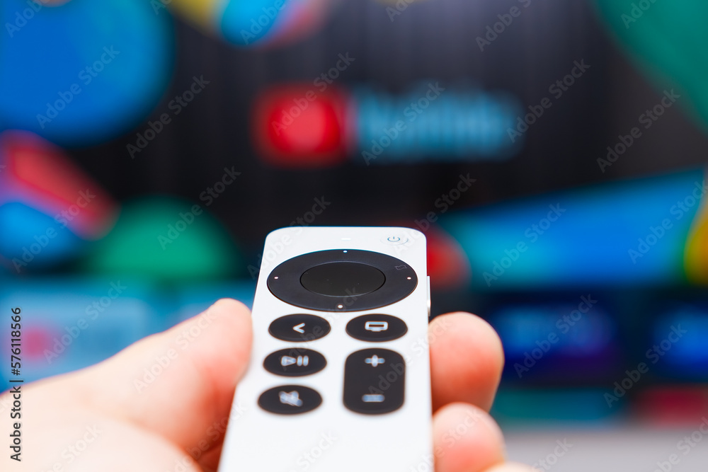 Foto de Youtube on Apple TV showing on the screen of TV. Man hands