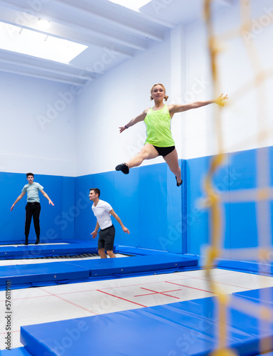 Portrait of positive athletic girl during training in trampoline center. Sport lifestyle concept.. © JackF