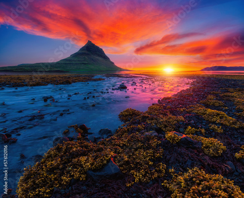 An incredible view of the famous peak of the Kirkjufell volcano at dawn. Iceland, Europe.