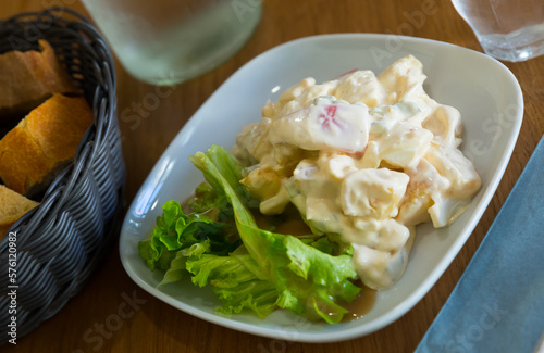 Tasty salad with tomato, pineapples, cucumbers, lettuce, creamy and honey sauces