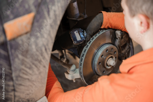 Replacement and repair of wheels and shock absorbers on a car in a garage