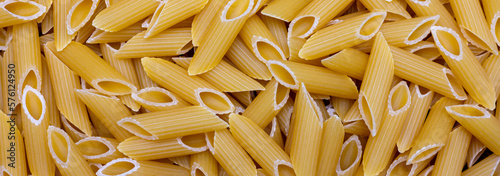 banner or close-up seen from above of uncooked macaroni pasta photo