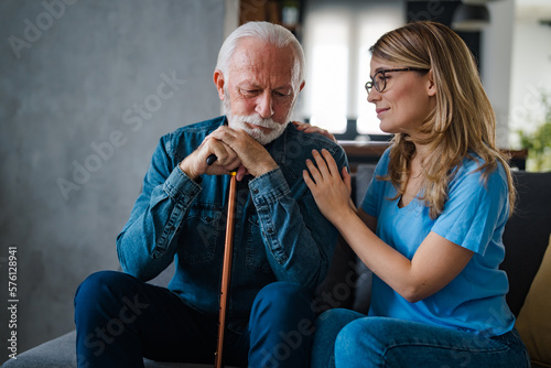 Obraz na plátne Young nurse spend time with old man, shares his pain, express empathy caring abo