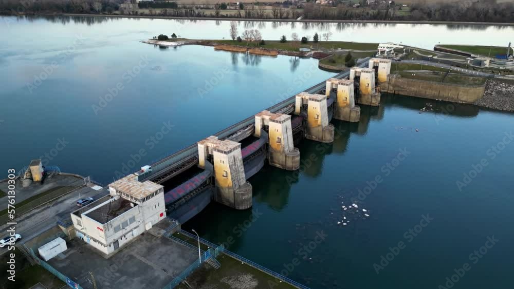Water dam on the Rhone River and water filtration treatment plants. Overlooking the surrounding mountains in the Ardeche and the wind farm Water dam on the Rhone River and water filtration treatment plants. Overlooking the surrounding mountains in the Ardeche and the wind farm