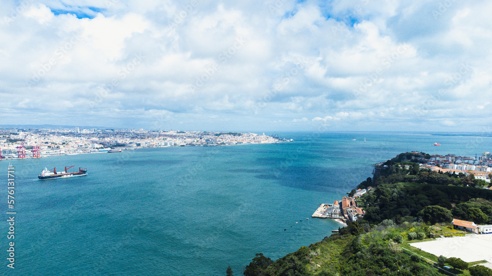 Lisbon, Portugal. April 11, 2022: Panoramic landscape with a view of the Tagus river and 25 de Abril bridge.