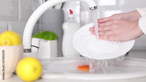 girl washing dishes in the kitchen