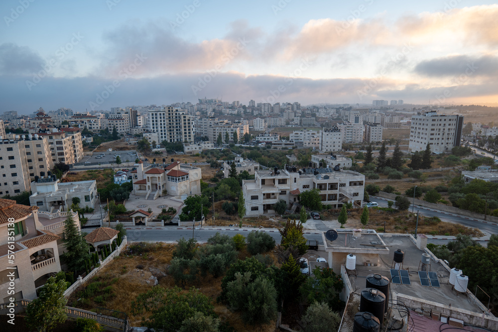 Ramallah Cityscape at Dawn with Sunset, High Buildings, and Trees Facing the Sun