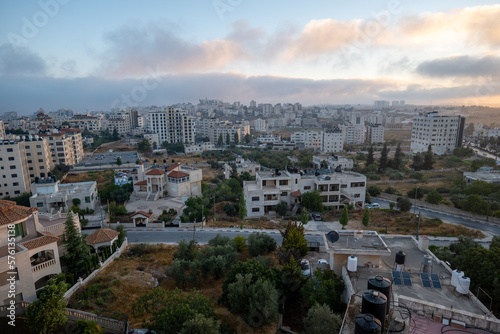 Obraz na płótnie Ramallah Cityscape at Dawn with Sunset, High Buildings, and Trees Facing the Sun w salonie