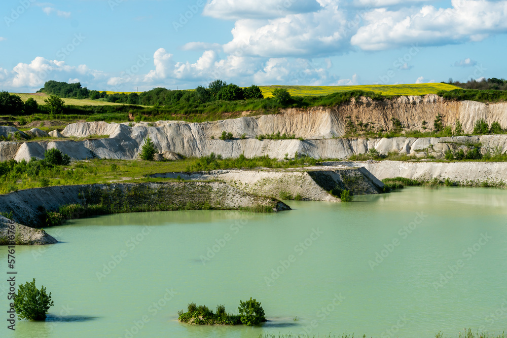 A large sand quarry and a lake. A flooded old abandoned quarry complex. Extraction of sand and stone for industrial applications. A large sand quarry and a lake. A flooded old abandoned quarry complex. Extraction of sand and stone for industrial applications.