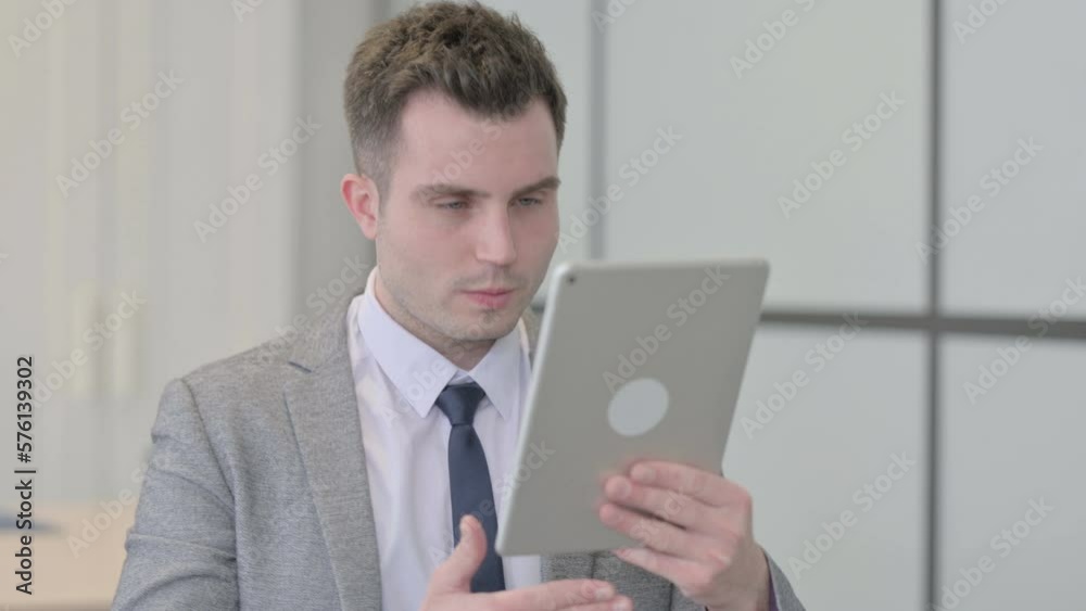 Young Businessman Doing Online Video Chat on Tablet