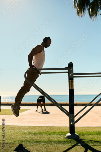 Obraz na plátně young guy exercising with calisthenics workout in an outdoor gym