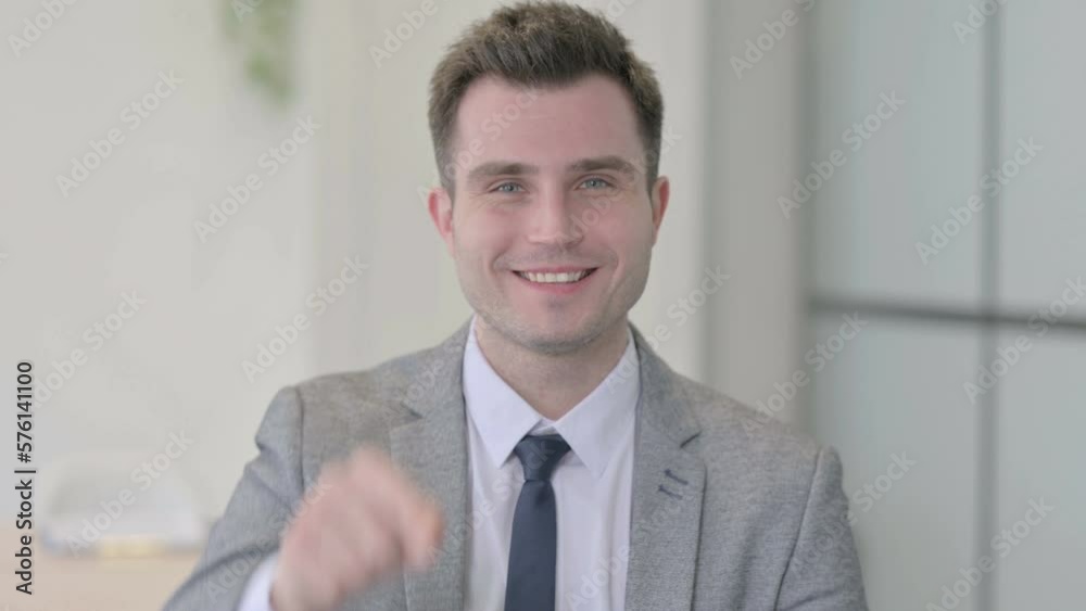 Portrait of Young Businessman Pointing at the Camera Portrait of Young Businessman Pointing at the Camera