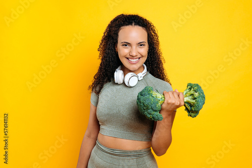 Photographie Excited joyful latino or brazilian young athletic woman with curly hair, with he