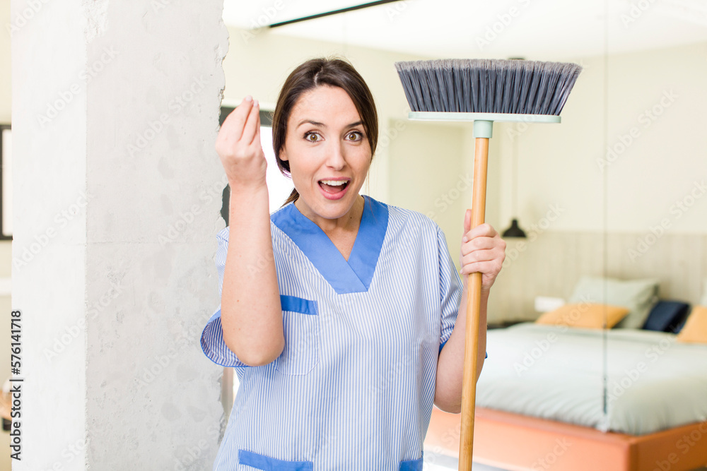 young pretty woman making capice or money gesture, telling you to pay. housekeeper concept young pretty woman making capice or money gesture, telling you to pay. housekeeper concept