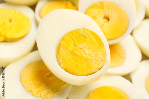 Halves of delicious boiled eggs as background, closeup