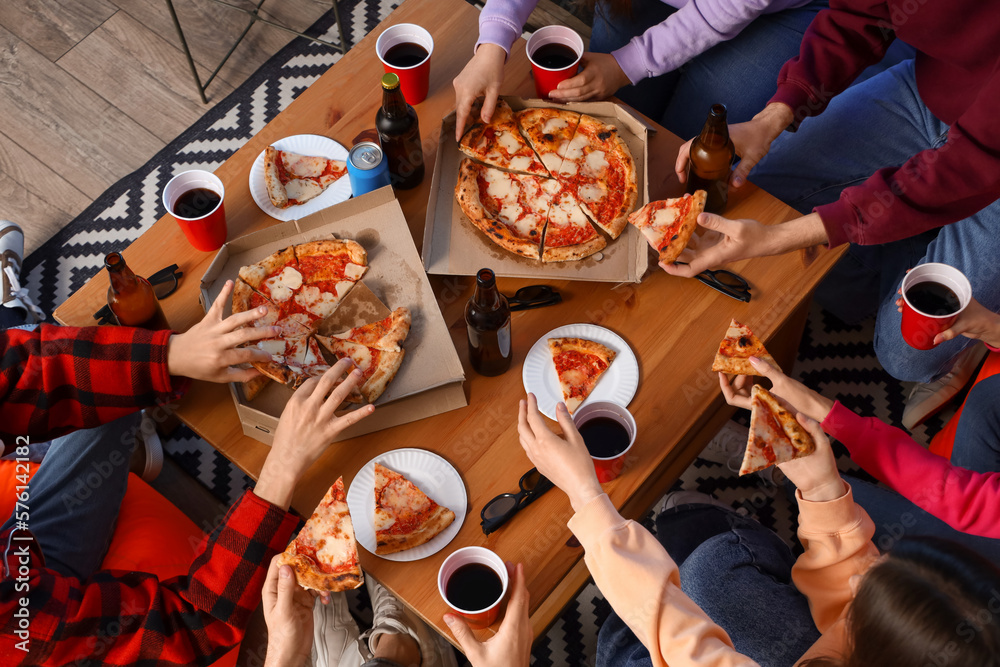 Group of friends with tasty pizza and drinks at home, top view