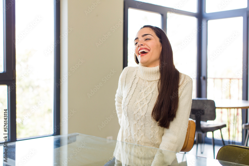 pretty caucasian woman looking happy and friendly, smiling and winking an eye at you with a positive attitude