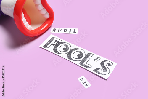 Obraz na plátne Toy megaphone and text APRIL FOOL'S DAY on color background