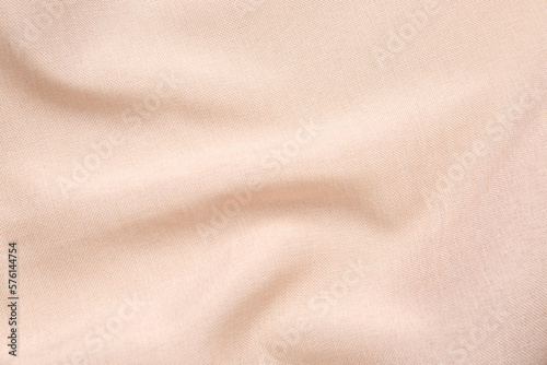 Closeup view of crumpled beige fabric as background