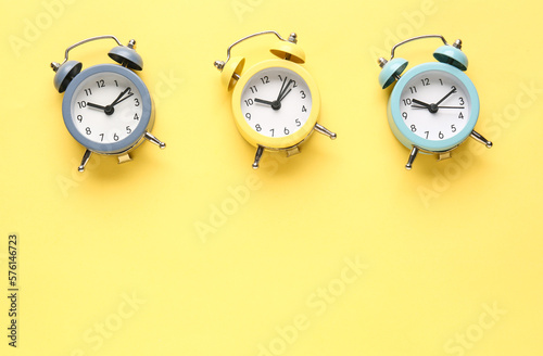 Alarm clocks on yellow back...