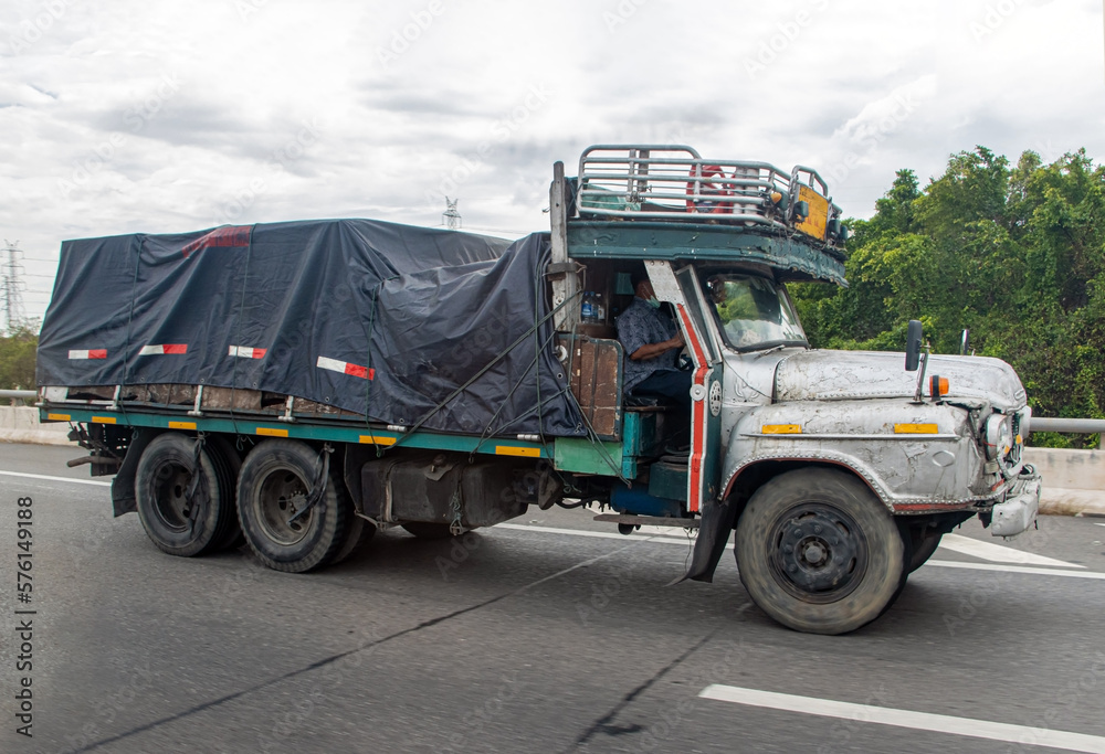 An old truck is driving on the highway, Thailand
