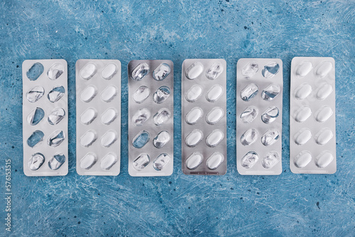 Obraz na plátně multivitamins pills or medicine tablets into blister packs next to other empty o