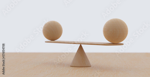 Wooden spheres balancing on seesaw. Concept of harmony and balance in life and work