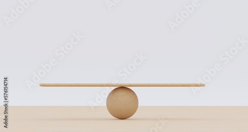 Wooden spheres balancing on seesaw. Concept of harmony and balance in life and work photo