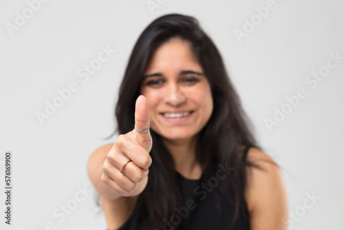 Blurred Indian girl shows thumb up