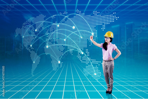 Asian woman with safety helmet with digital world map